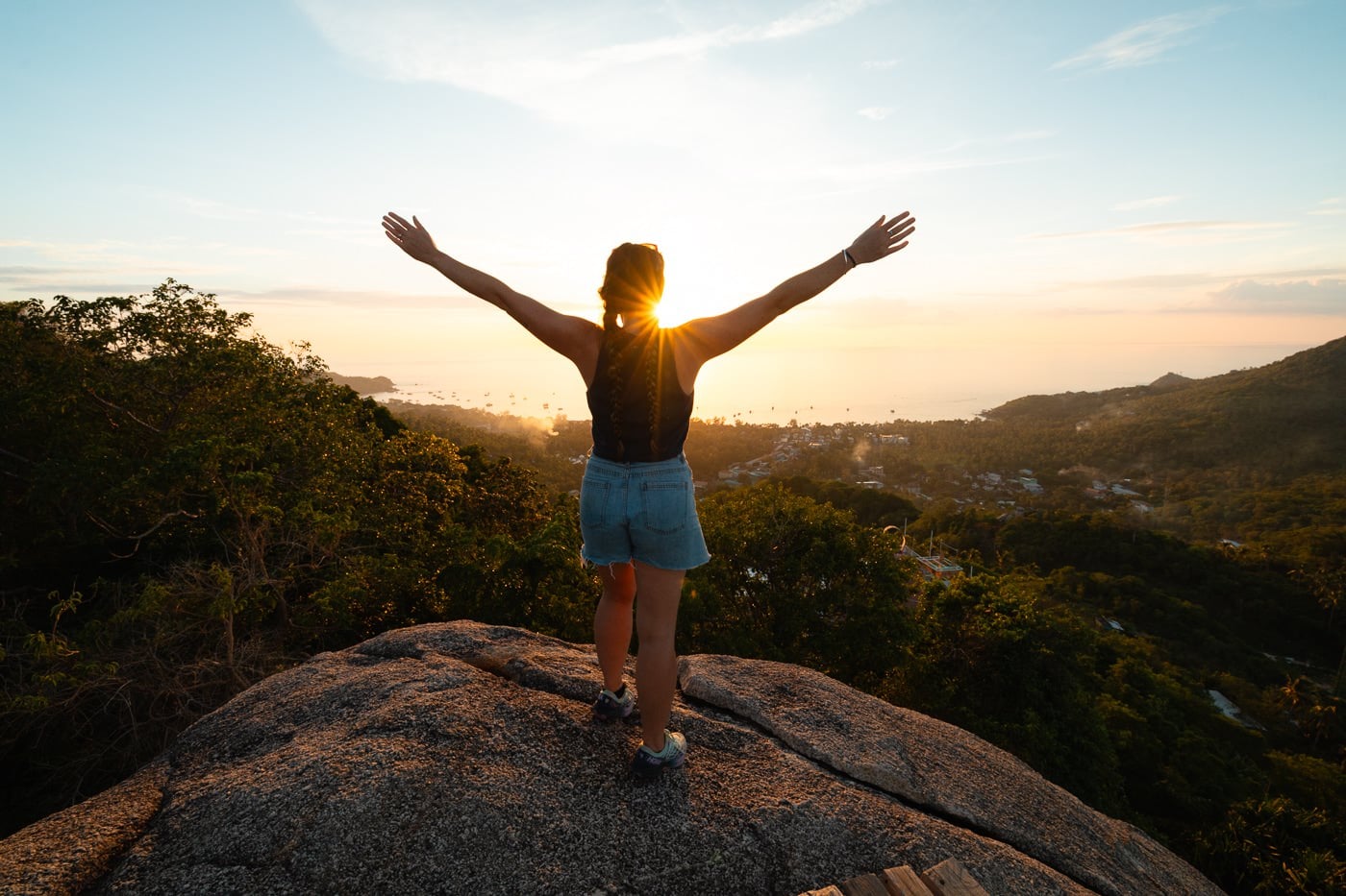 Koh Tao Vs Koh Samui: Which Island Should You Pick? Hiker standing on the boulders at fraggle rock viewpoint above sairee beach, koh tao