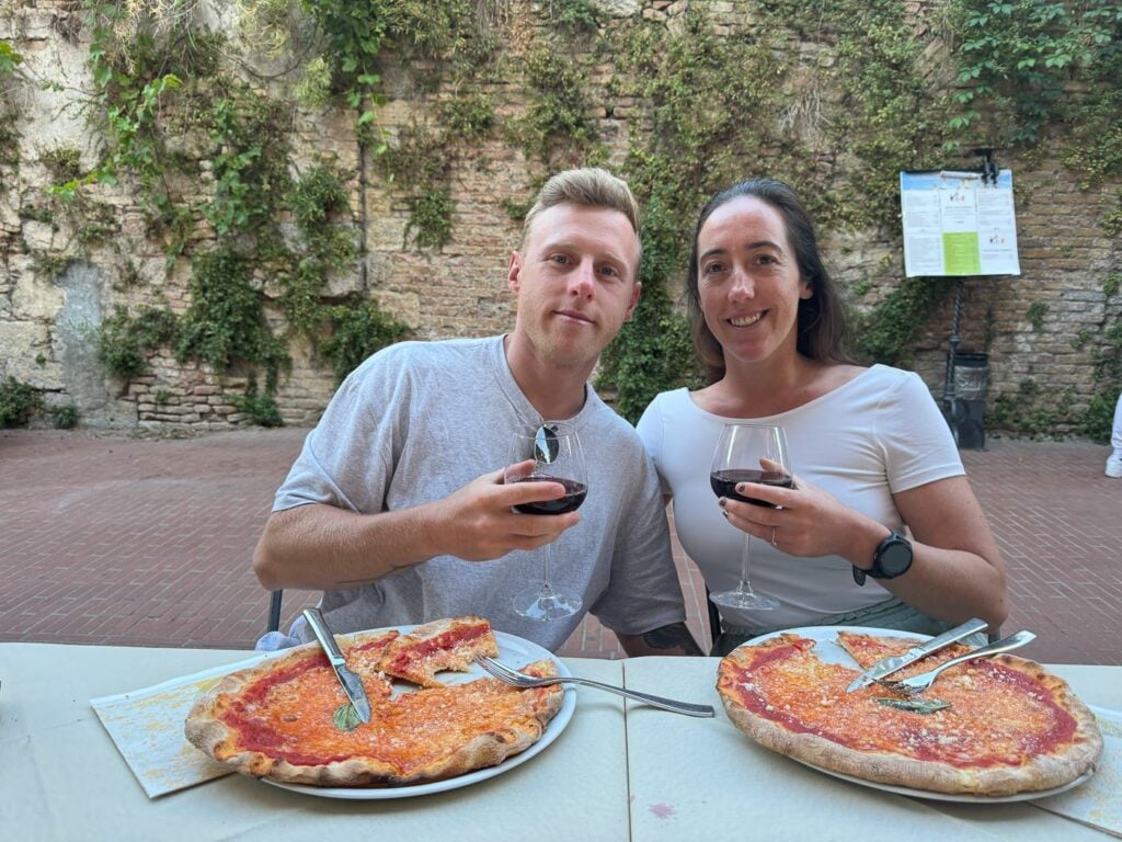 Travelers eating pizza in Italy