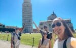 Travelers uploading a selife at the leaning tower of pisa, italy