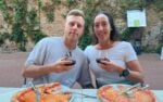 Couple take a travel selfie while sharing a meal in italy