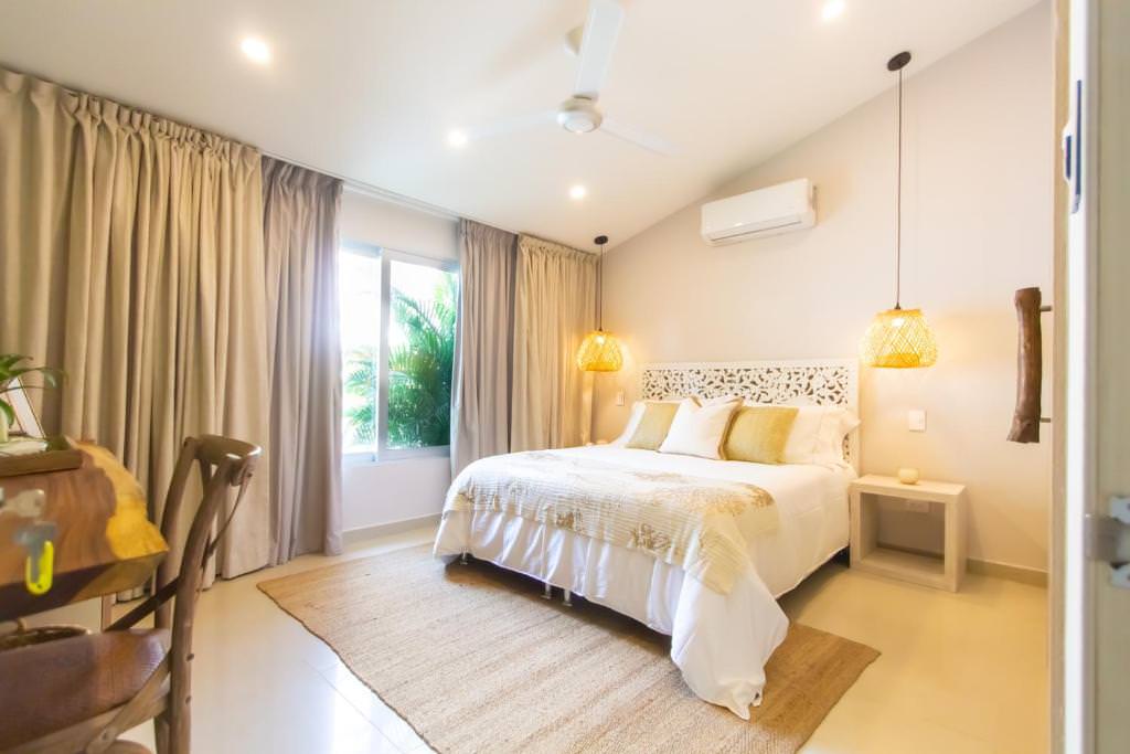 Bedroom with large window view at Hotel Mandalas House