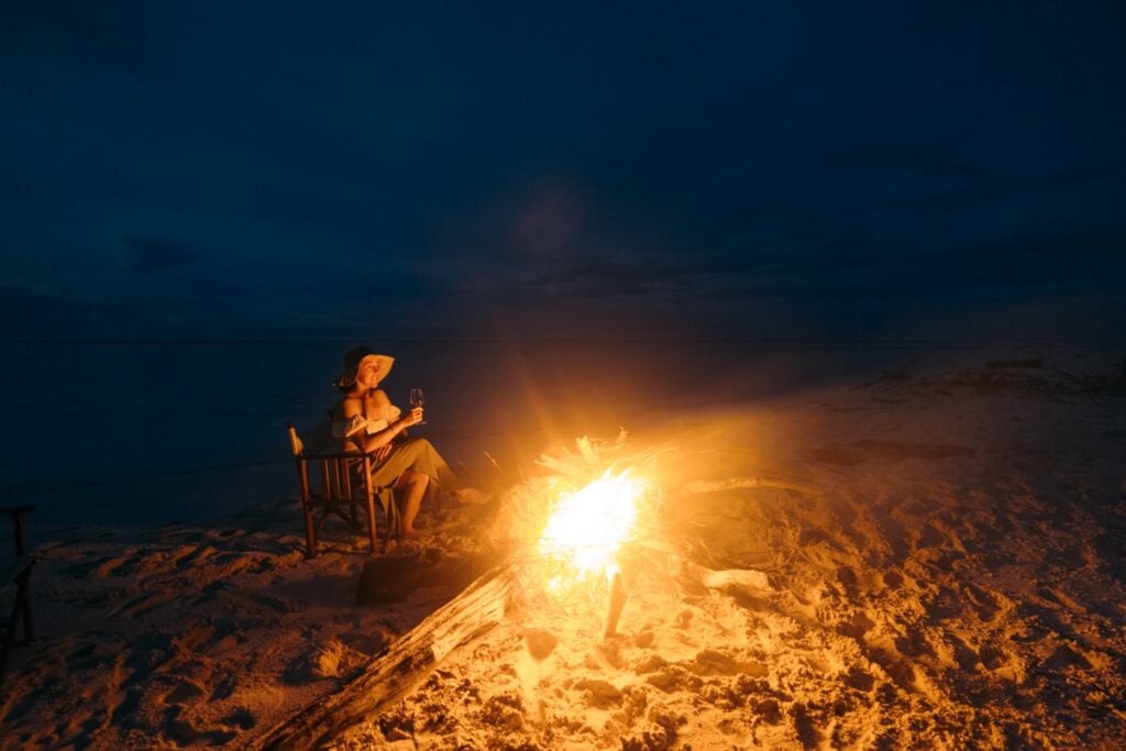 Fatboys Resort Review: My Honest Take After Visiting Traveler enjoying a bonfire in the solomon islands