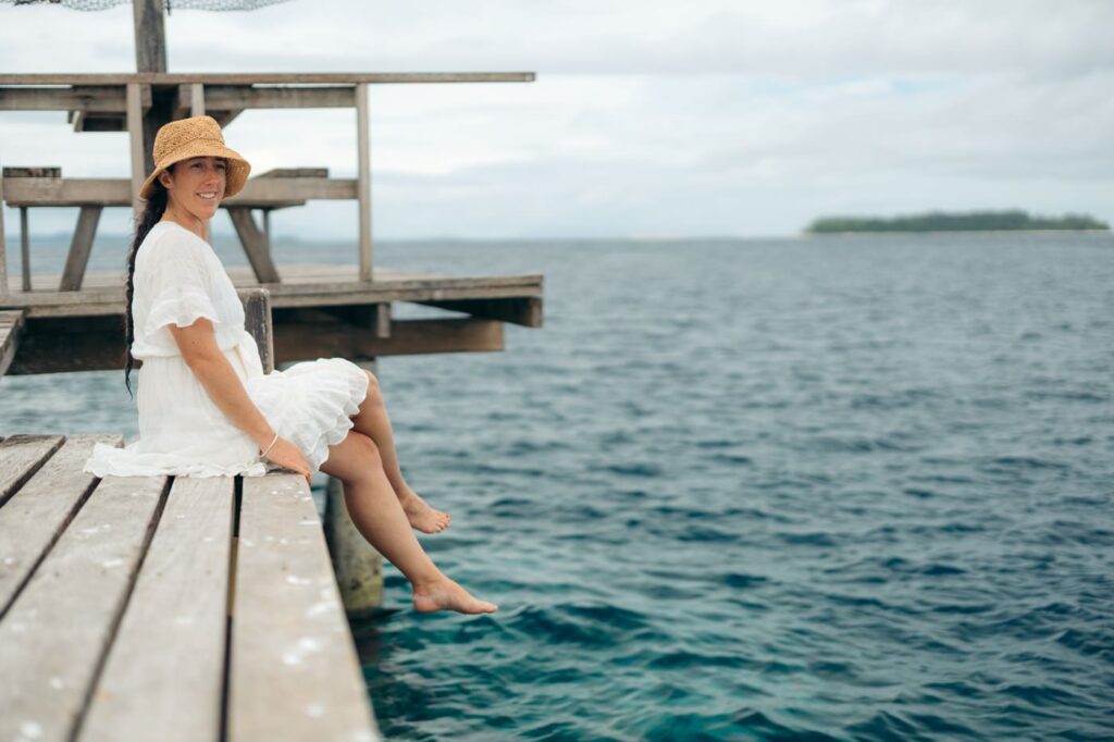 Traveler sitting at the pier on Kennedy Island