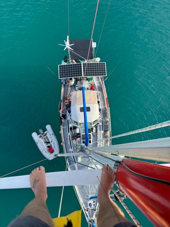 About Olly Gaspar &Amp; We Seek Travel Looking down at a sailing boat from the spreaders