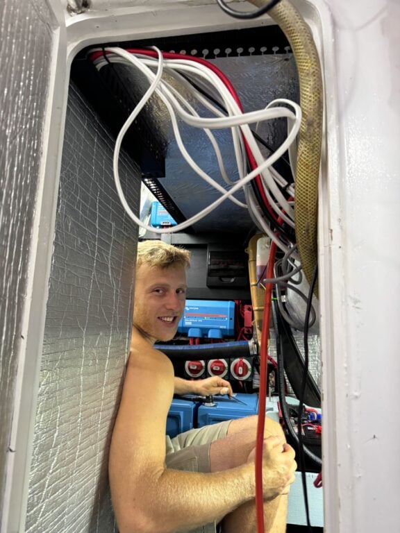 About Olly Gaspar &Amp; We Seek Travel Olly doing electrical wiring on his boat