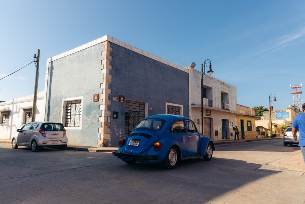 Car on scenic street in Valladolid, Mexico