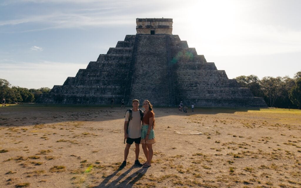 Couple standing at Chichen Itza at Sunrise