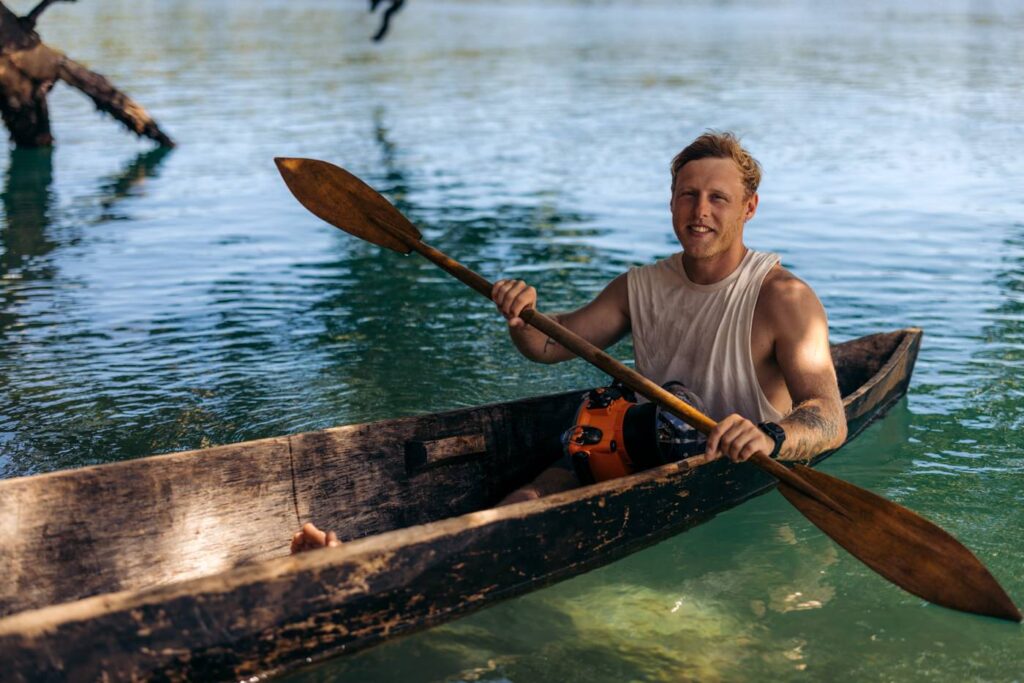 Olly Gaspar paddling traditional dug out canoe in the Solomon Islands