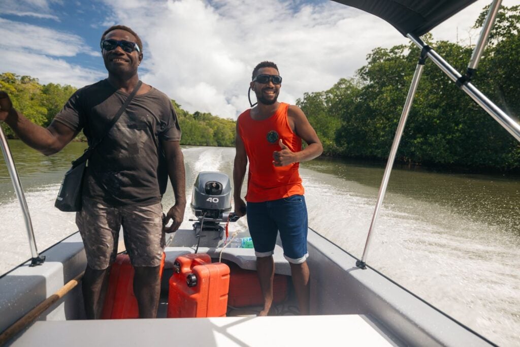 Smiling people on a boat in the Solomon Islands