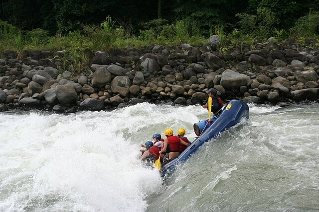 Group of people white water rafting