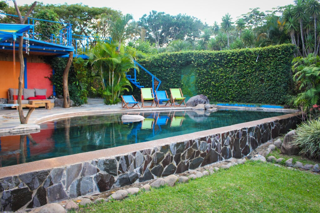 Quiet pool with lounge furniture at El Sol Monteverde