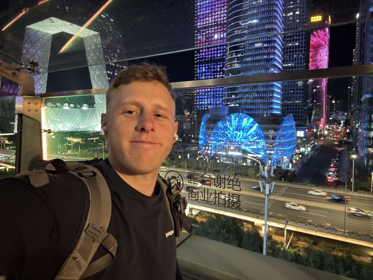 Jambosim Review: Is This Cheap Esim Worth It? (Honest Test) Olly gaspar taking a selfie at the china world trade center in beijing at night with the cbd skyline lit up behind him