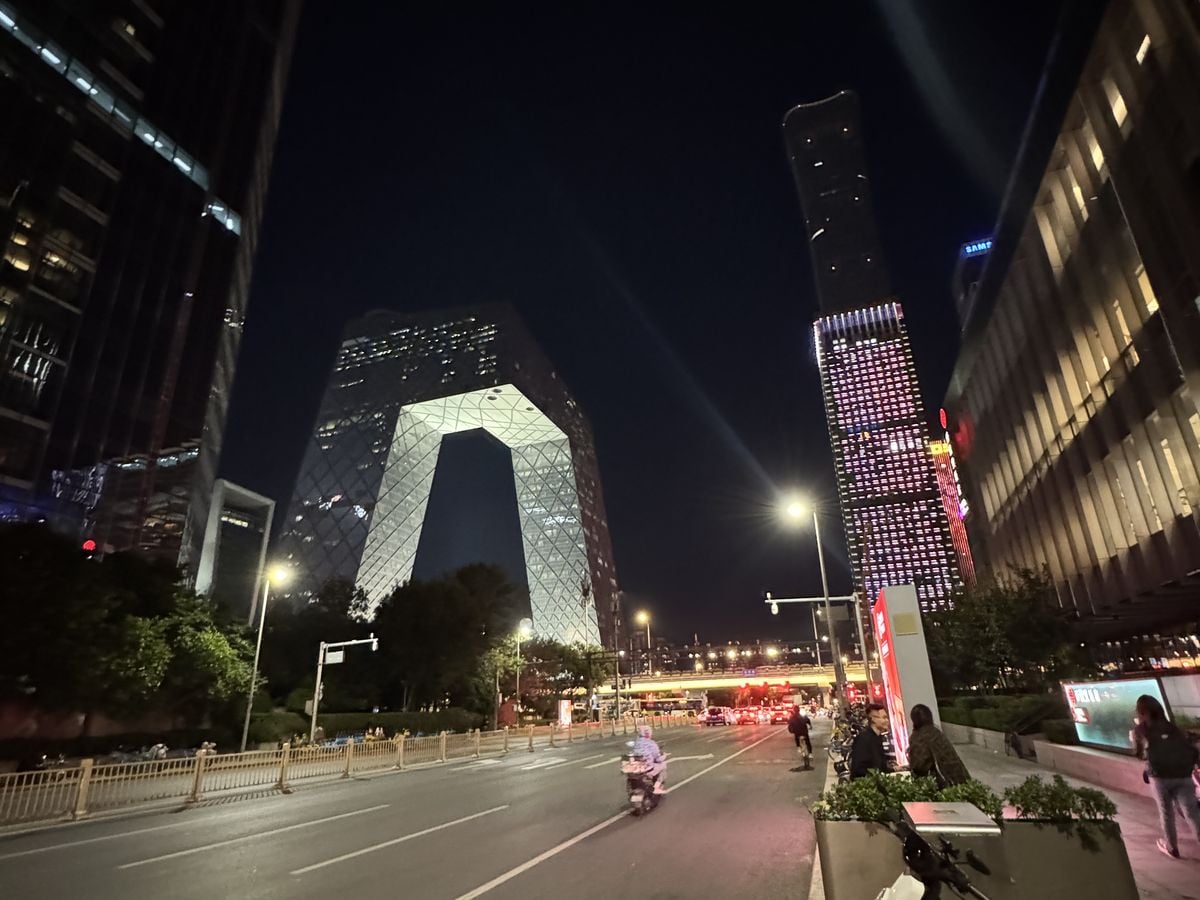 Jambosim Review: Is This Cheap Esim Worth It? (Honest Test) A wide street in beijing cbd at night with the cctv headquarters building lit up in the distance